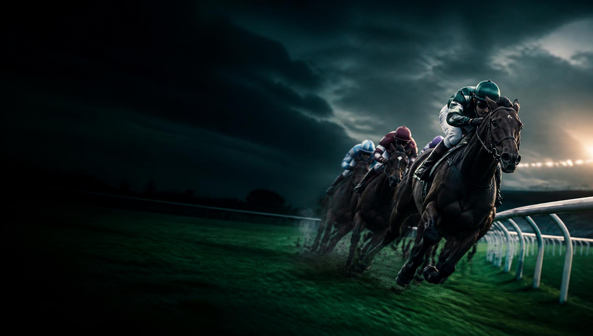 Racehorses rounding the turn at dusk